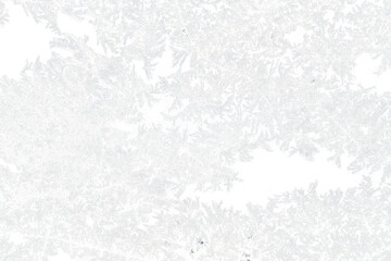 snow frost in the form of natural patterns on the window pane against the background of the morning sky