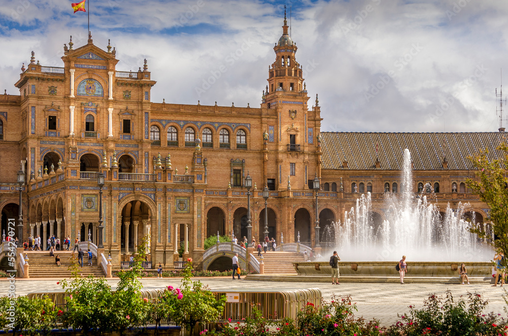 Panorama of the Spain Square Plaza de Espana in Seville, with bridges over the canal, lake, fountain, towers and main entrance to the building. Example of Moorish and Renaissance revival.