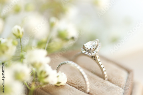 Bride diamond wedding ring and engagement band in a cream velvet ring box