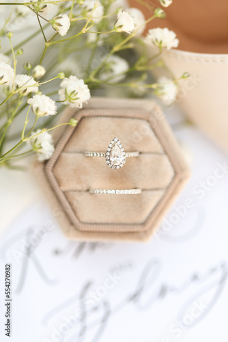 Bride diamond wedding ring and engagement band in a cream velvet ring box