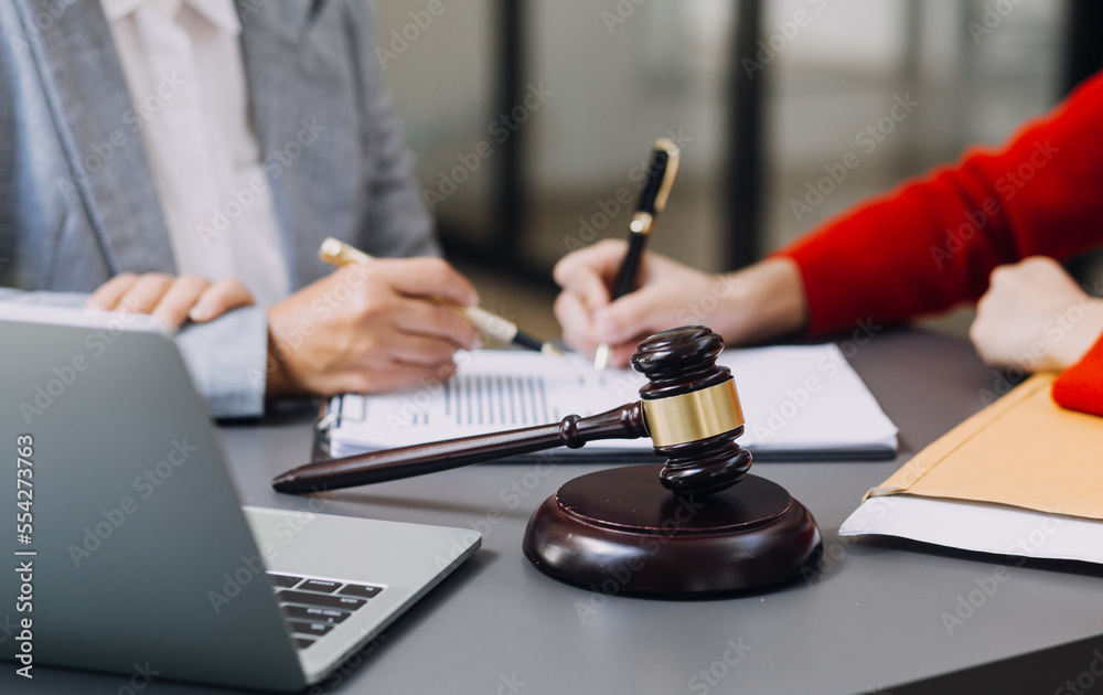justice and law concept.Male judge in a courtroom on wooden table and Counselor or Male lawyer working in office. Legal law, advice and justice concept.
