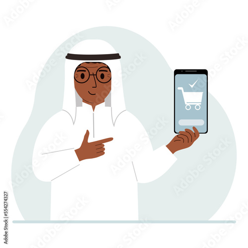 A man holds a mobile phone in his hand with an application for online shopping. The phone has a shopping cart.