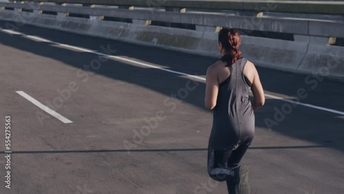 Wallpaper Mural Woman, running or city fitness in weightloss goals, fat management or healthcare wellness in slow motion workout, training or road exercise. Runner, sports athlete or normal person in street marathon Torontodigital.ca