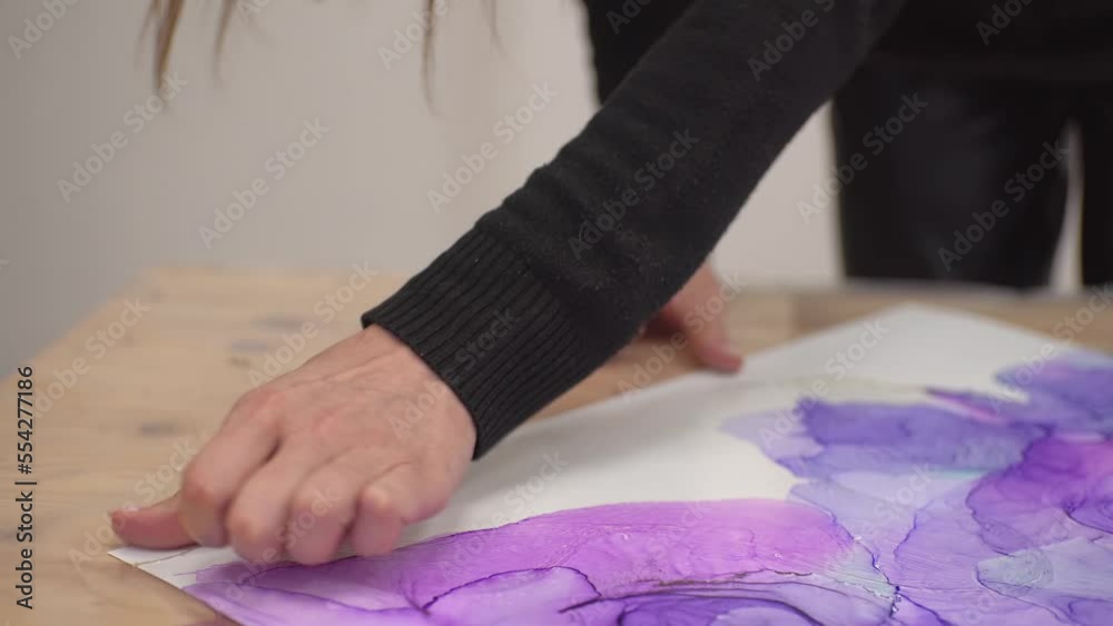 the girl vigorously removes the glue from the picture. High-quality shooting in 4k format the girl vigorously removes the glue from the picture. High-quality shooting in 4k format