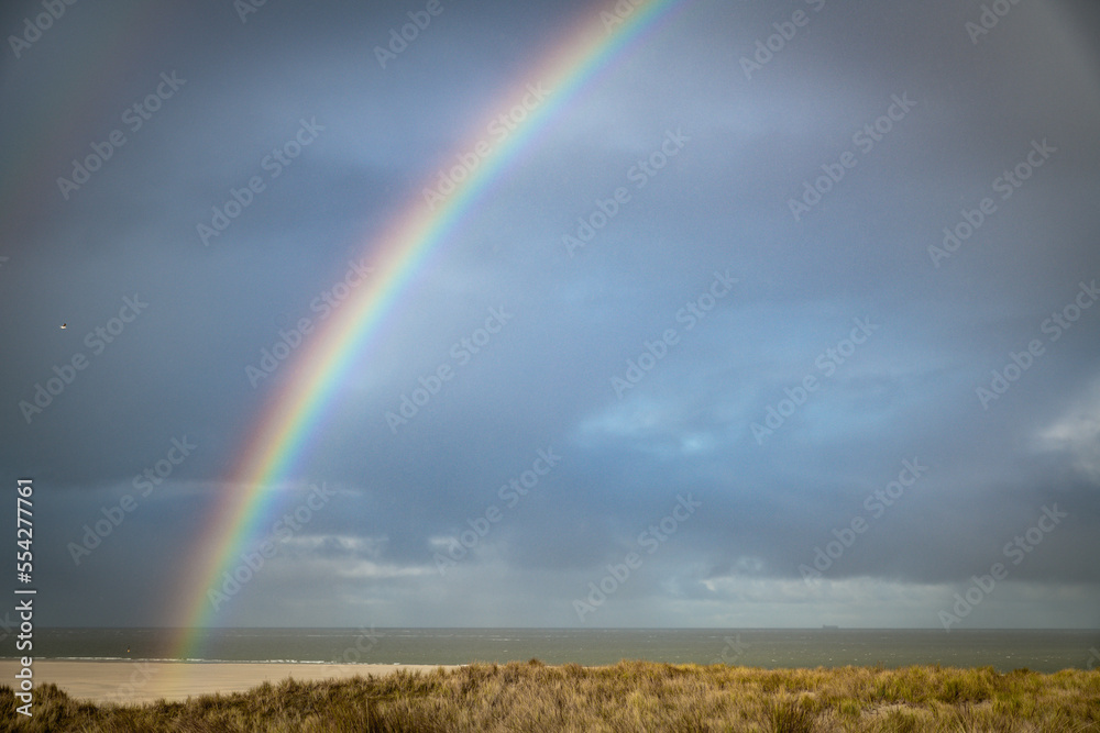 rain and sun and the rainbow over the beach rain and sun and the rainbow over the beach