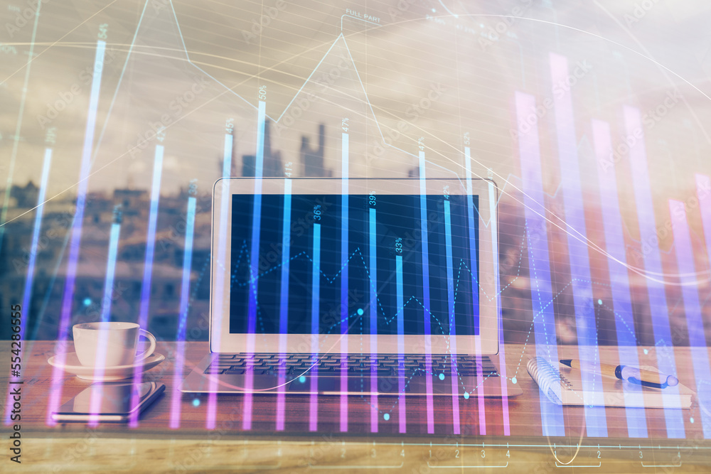 Forex Chart hologram on table with computer background. Double exposure. Concept of financial markets. Forex Chart hologram on table with computer background. Double exposure. Concept of financial markets.