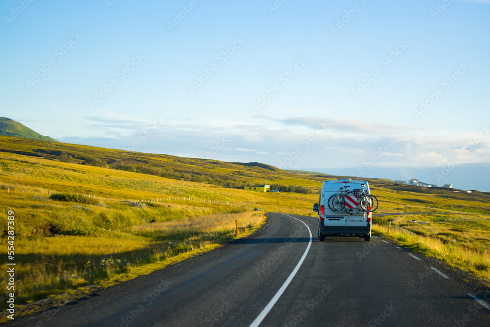 Family vacation cycle on a bus , road trip in a highway, green peaceful travel Eurotrip Iceland