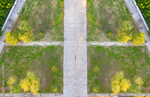 Perpendicular aerial view on a park with grass and roads.