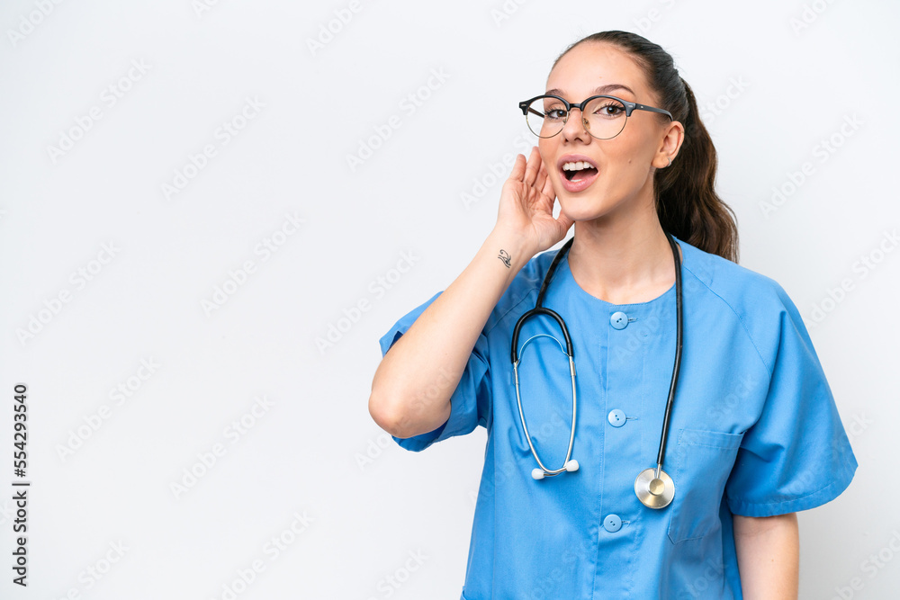 Young caucasian surgeon doctor woman isolated on white background listening to something by putting hand on the ear Young caucasian surgeon doctor woman isolated on white background listening to something by putting hand on the ear