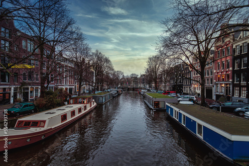 AMSTERDAM, NETHERLANDS - Dec 06, 2019: Canal in Amsterdam after sunset