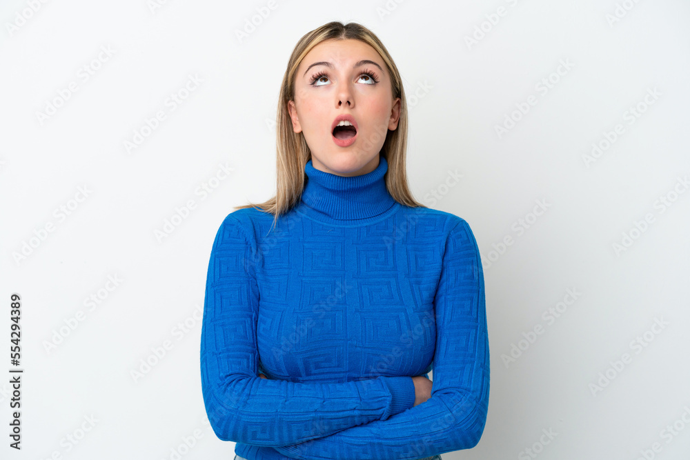 Young caucasian woman isolated on white background looking up and with surprised expression Young caucasian woman isolated on white background looking up and with surprised expression