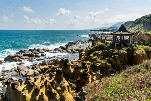 Panoramic view of the rocky coastal landscape from the Scenic Pavilion at Heping Island Park in Keelung, Taiwan, with Keelung Islet just behind. photo