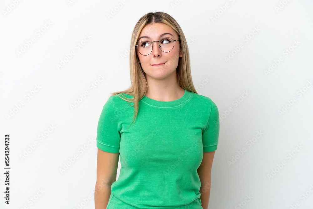 Young caucasian woman isolated on white background having doubts while looking up Young caucasian woman isolated on white background having doubts while looking up