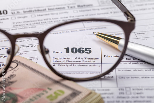 Income tax with instruction  money and glasses. Tax payment and filing concept