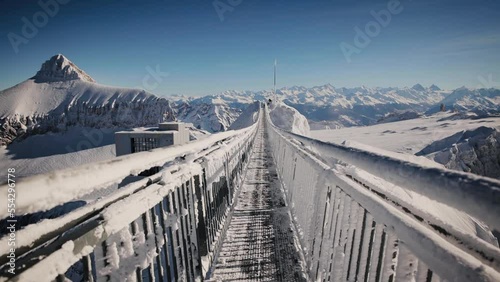 Peak Walk is a pedestrian suspension bridge linking two mountain peaks in the Swiss Alps on an altitude of 3000 meters. Steadicam shot photo