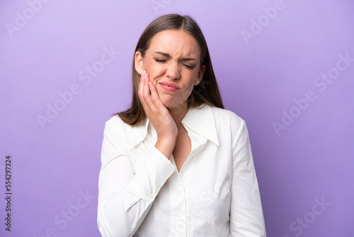 Young caucasian woman isolated on purple background with toothache