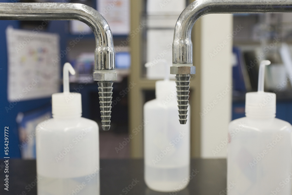 Plastic rinse bottles with faucets in a laboratory Plastic rinse bottles with faucets in a laboratory