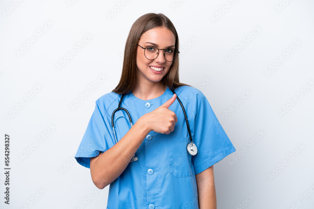 Young nurse caucasian woman isolated on white background giving a thumbs up gesture Young nurse caucasian woman isolated on white background giving a thumbs up gesture