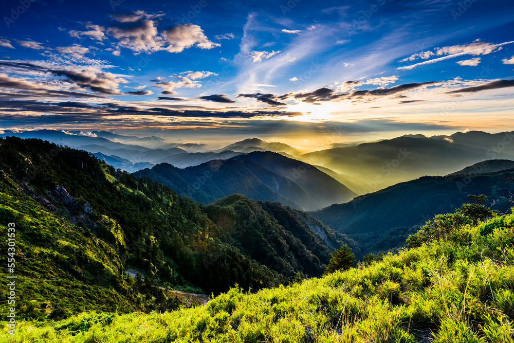 Layers of magnificent mountains at sunset with the sea of clouds background in Hehuanshan, Taiwan.