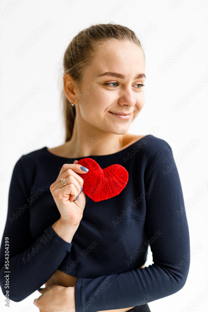 Cardio workout, sports woman holding a red heart.
