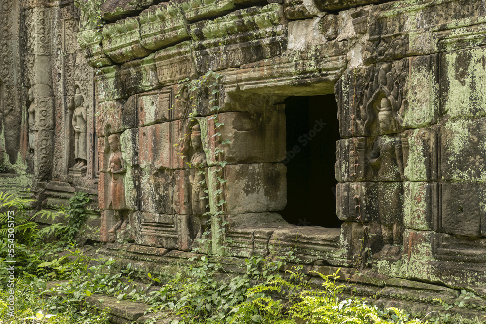 Window in stone wall decorated with bas-reliefs, Preah Khan, Angkor Wat; Siem Reap, Siem Reap Province, Cambodia Window in stone wall decorated with bas-reliefs, Preah Khan, Angkor Wat; Siem Reap, Siem Reap Province, Cambodia