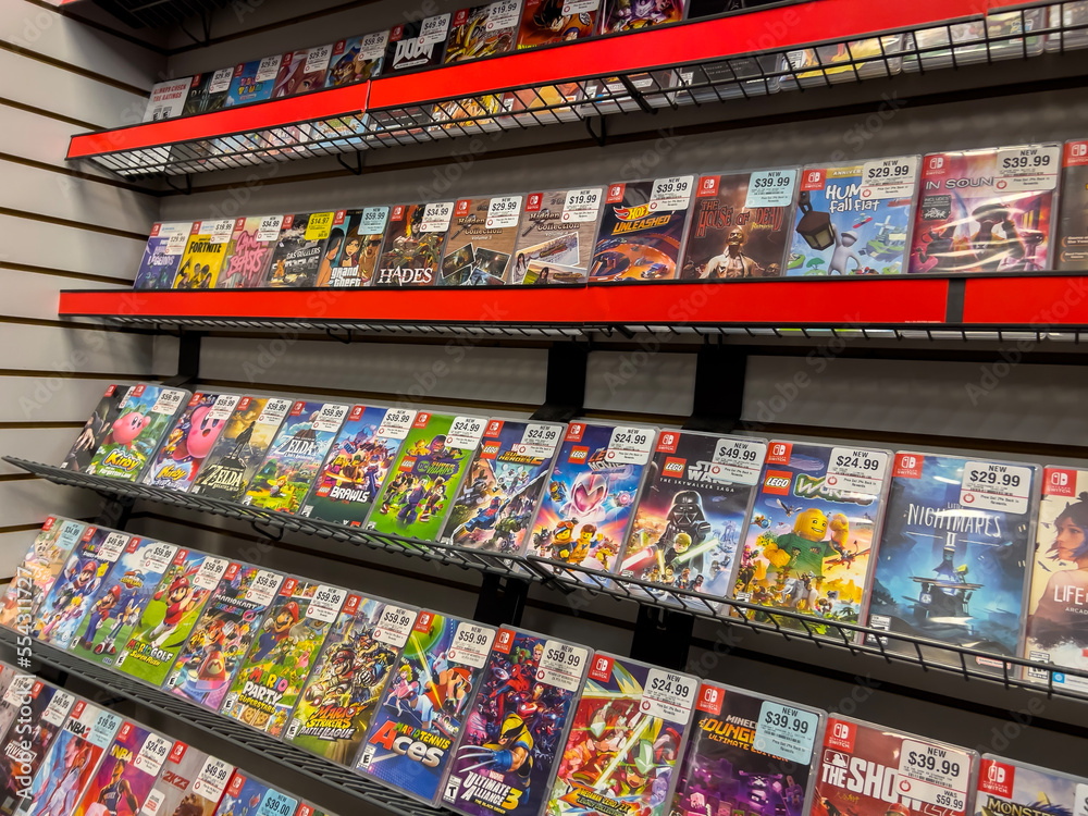 Fototapeta premium Seattle, WA USA - circa December 2022: Selective focus on used video games for sale inside a GameStop gaming store.