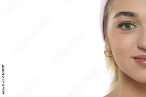 Close up half portrait of beautiful young smiling woman face on a white background