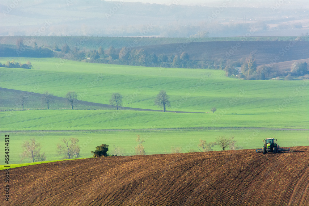 The tractor works the land