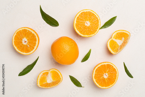 Fresh oranges with leaves on concrete background