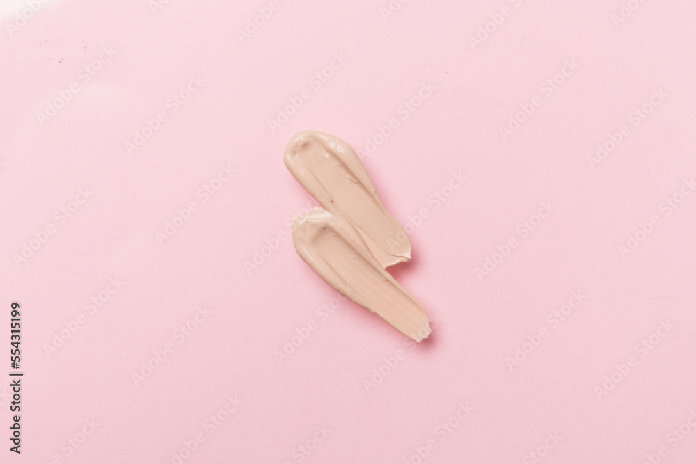 Foundation smudges on color background, top view
