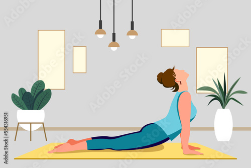 Yoga studio at home. Woman in pose yoga on mat. Yoga classes at home. Interior of a modern apartment. Yoga concept.