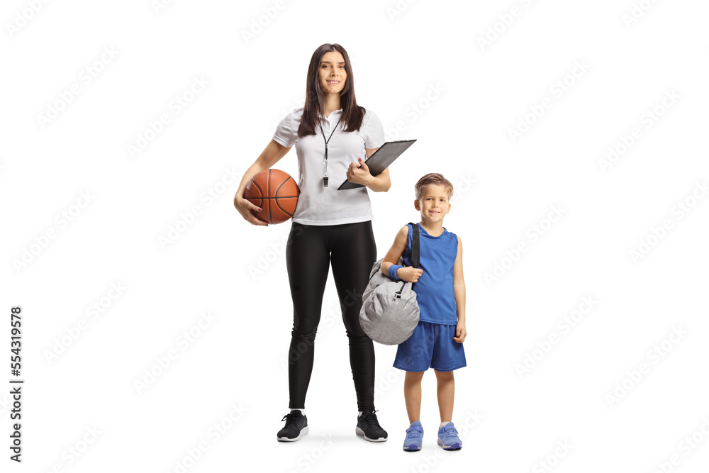 Full length portrait of a female basketball coach with a whistle holding a clipboard and standing with a boy Full length portrait of a female basketball coach with a whistle holding a clipboard and standing with a boy