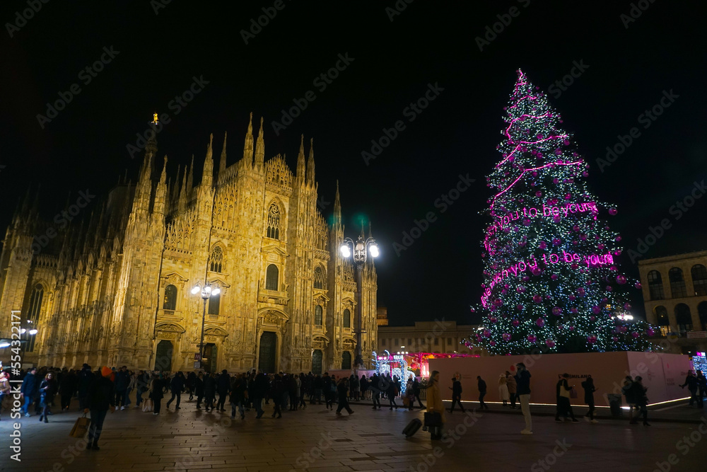 Obraz premium Panorama of the Piazza Duomo square on the New Year and Christmas tree. Albero di Natale with colored lights. City at night. One night ahead. Multi-colored lights. Milan, Italy, December 