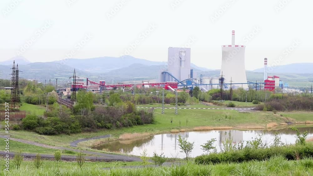 Huge pipes of a thermal power plant smoke slightly in the production process. Industrial landscape, atmospheric pollution, electricity production using the concept of burned fuel. Pollution Huge pipes of a thermal power plant smoke slightly in the production process. Industrial landscape, atmospheric pollution, electricity production using the concept of burned fuel. Pollution