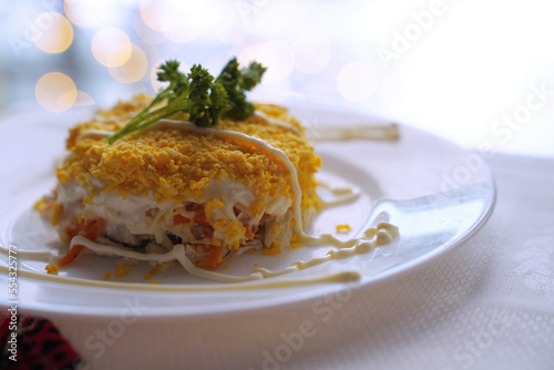 Obraz na płótnie Homemade mimosa salad. Traditional Ukrainian food on the table with embroidered tablecloth. w salonie