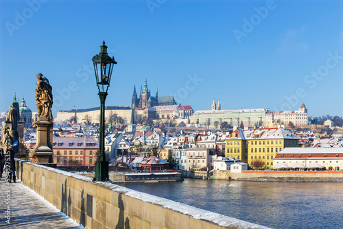 Obraz na plátně Sunny snowy Prague Lesser Town with gothic Castle from Charles Bridge and its ba