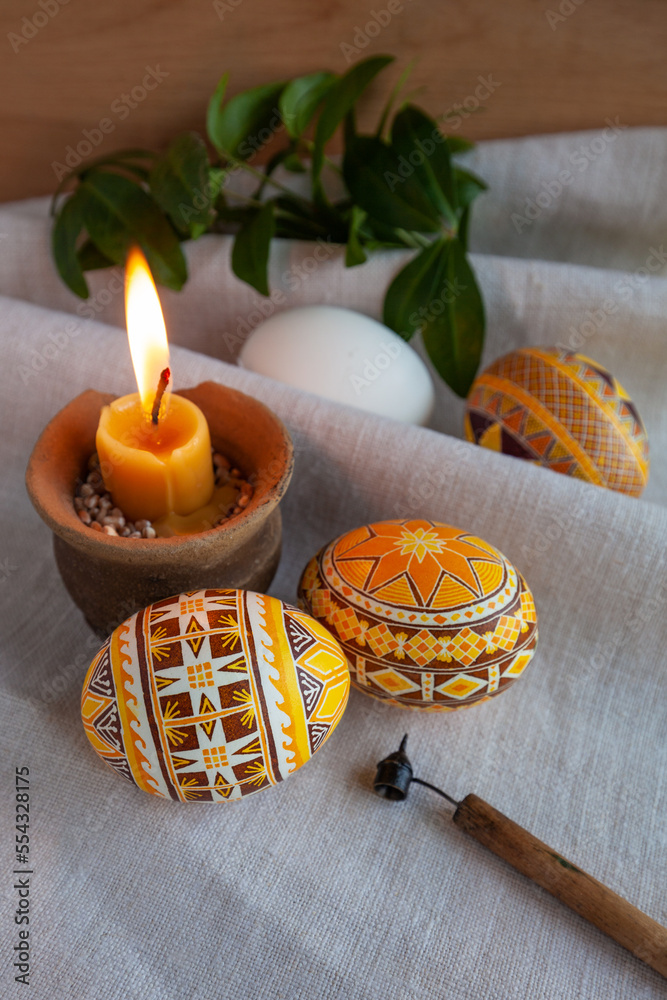 Ukrainian Easter eggs in yellow tones on the background of linen fabric