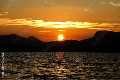 Sunset behind hills and trees and sea  clouds looks like solar storm  Tisan island and Ta  ucu