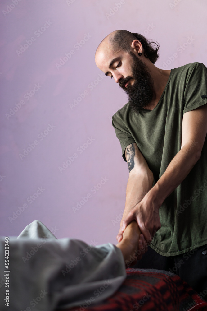 Obraz premium Physiotherapist giving arm massage to an unrecognizable person. Alternative medicine.