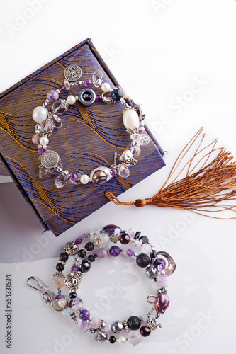 stylish jewelry semiprecious bracelets with present box around white background. hobby and fashion concept.