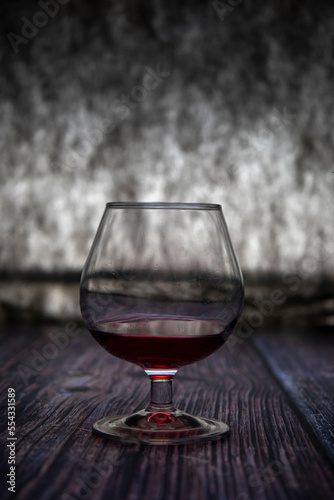 A glass of red wine on the table.