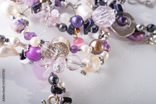 different stylish jewelry bracelets with semiprecious  around  white background. hobby and fashion concept. close up photo