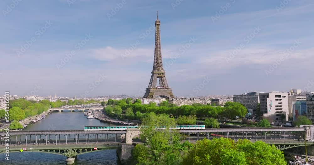 Drone view of the most popular attraction in the world in Paris. Drone flying near the eiffel tower in summer. The bridge of the old metro in the foreground