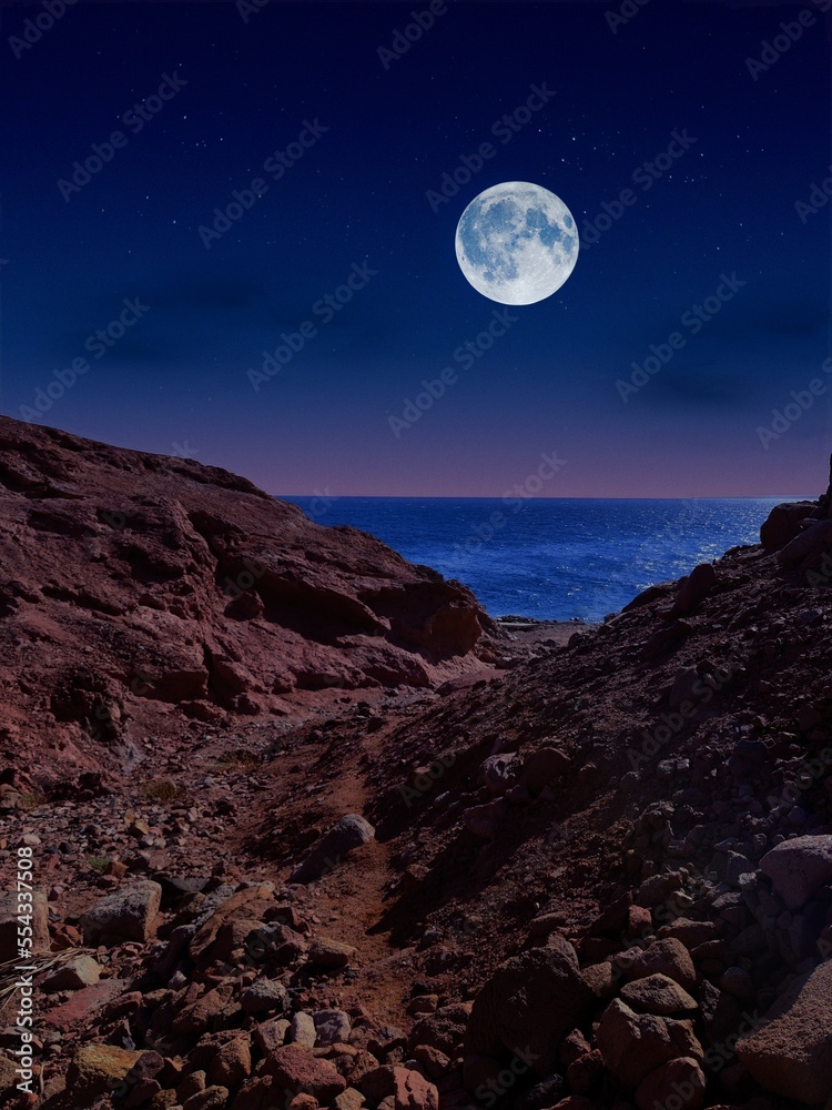 Scenic view of red sea at night with full moon above the sea and mountains
