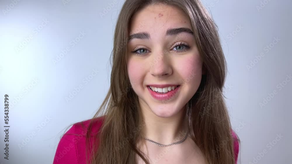 a beautiful girl with loose chic brown hair sends an air kiss to the camera and then straightens her hair woman with curly hair demonstrates your product a beautiful girl with loose chic brown hair sends an air kiss to the camera and then straightens her hair woman with curly hair demonstrates your product