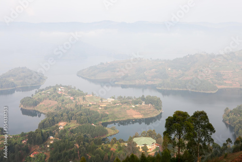 An early morning fog and haze cover the islands and hills of Lake Bunyonyi.; Lake Bunyonyi, Uganda photo