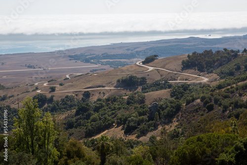 A view of the Pacific Ocean, the San Simeon coast, and the road leading to Hearst Castle.; Hearst Castle, San Simeon, California photo