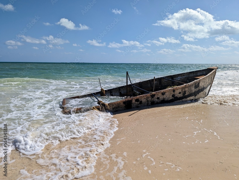 Horizontal sunken boat at beach of caribbean sea