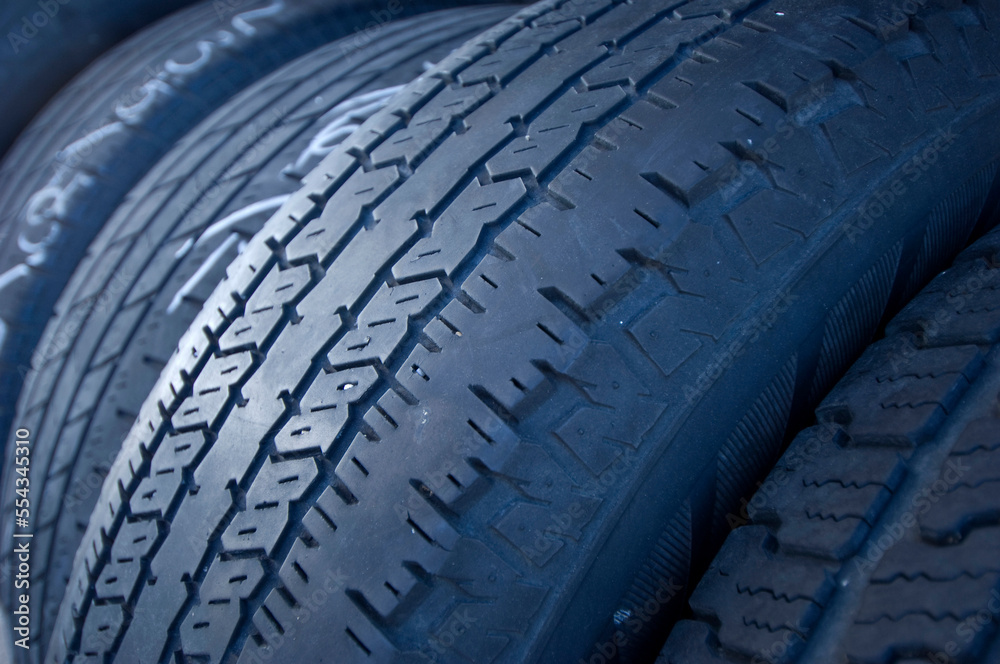 Close-up detail of worn treads on rubber vehicle tires; Lake Placid, Florida, United States of America Close-up detail of worn treads on rubber vehicle tires; Lake Placid, Florida, United States of America