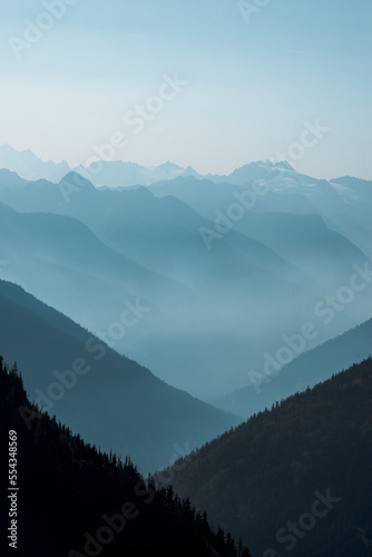 High mountain peak and range at the top of maple pass hike in north cascades national park in northern washington state united states of america with blue sky for copy space. Showing layers of blue